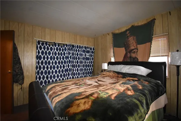 a bed sitting in a bedroom next to a window