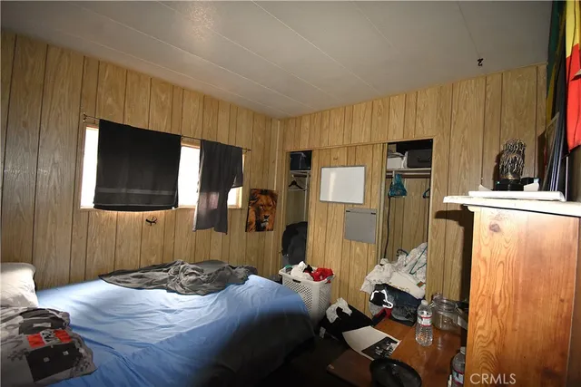 a bedroom with a bed and flat screen tv