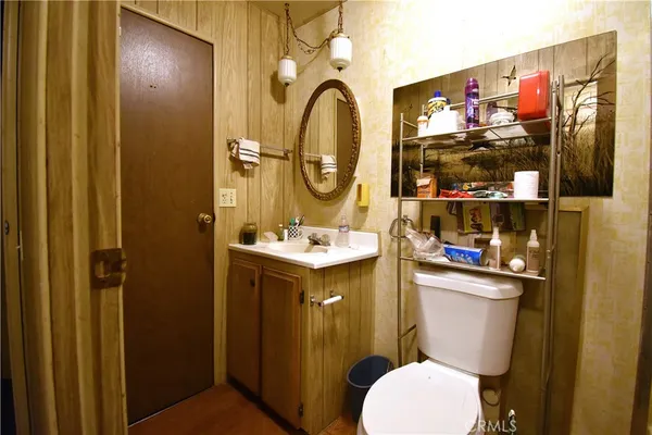 a bathroom with a sink mirror and toilet