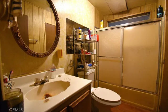 a bathroom with a sink toilet and mirror