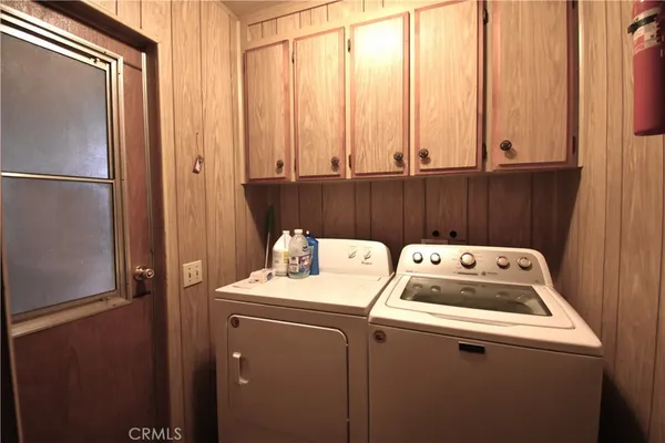 a view of room with wooden floor and furniture