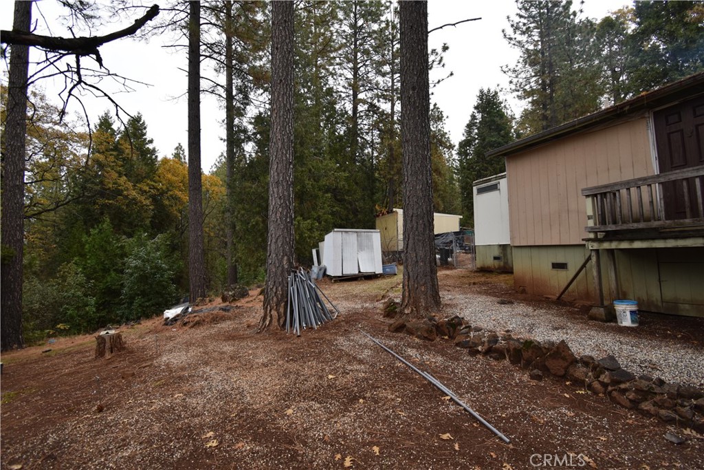 233 Renegade Road Oroville, CA 95966 - Photo 30 of 44 a backyard of a house with barbeque oven and trees
