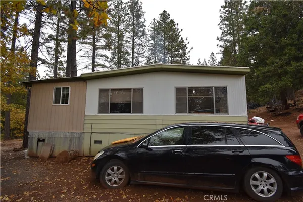 a view of a car parked front of a house
