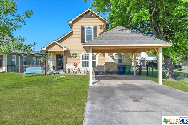 a front view of a house with a yard and porch