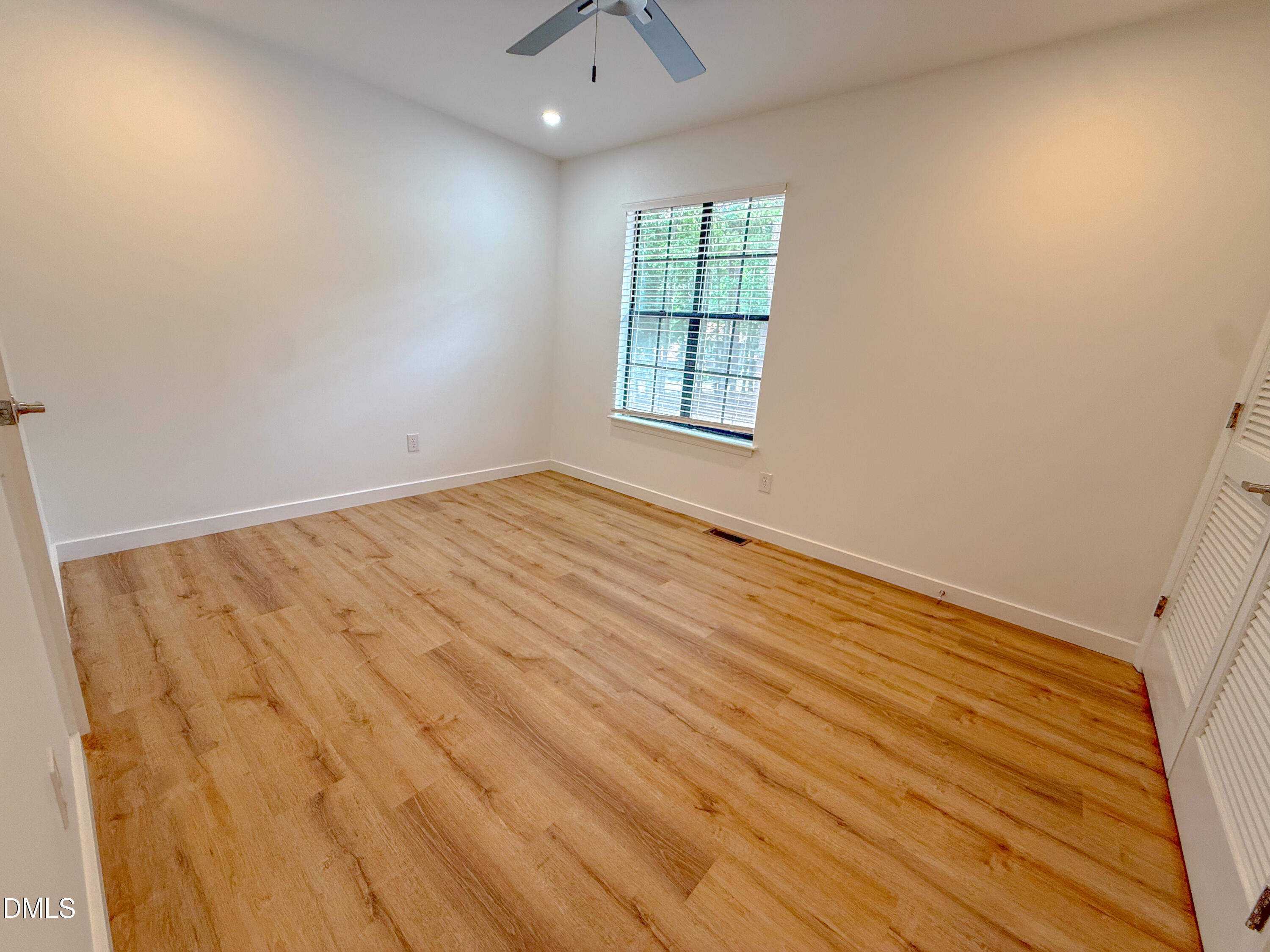4247 The Oaks Drive Raleigh, NC 27606 - Photo 14 of 21 an empty room with windows and closet