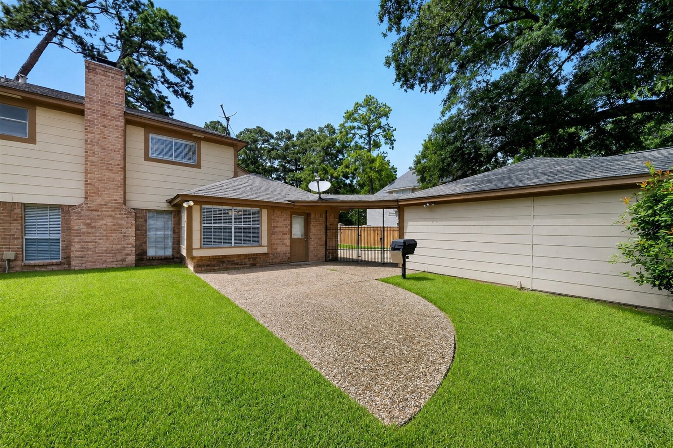 6507 Spring Leaf Drive Spring, TX 77379 - Photo 37 of 50 Backyard view highlighting the oversized lawn, private detached three car garage, and a functional covered breezeway.