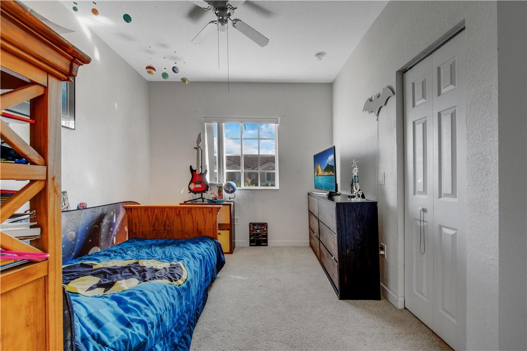5921 Riverside Avenue Tamarac, FL 33321 - Photo 19 of 22 a bedroom with a bed and a window