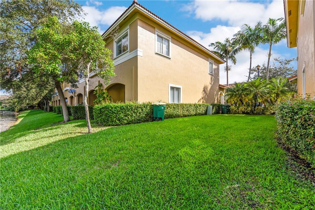 5921 Riverside Avenue Tamarac, FL 33321 - Photo 3 of 22 a view of an house with backyard and garden