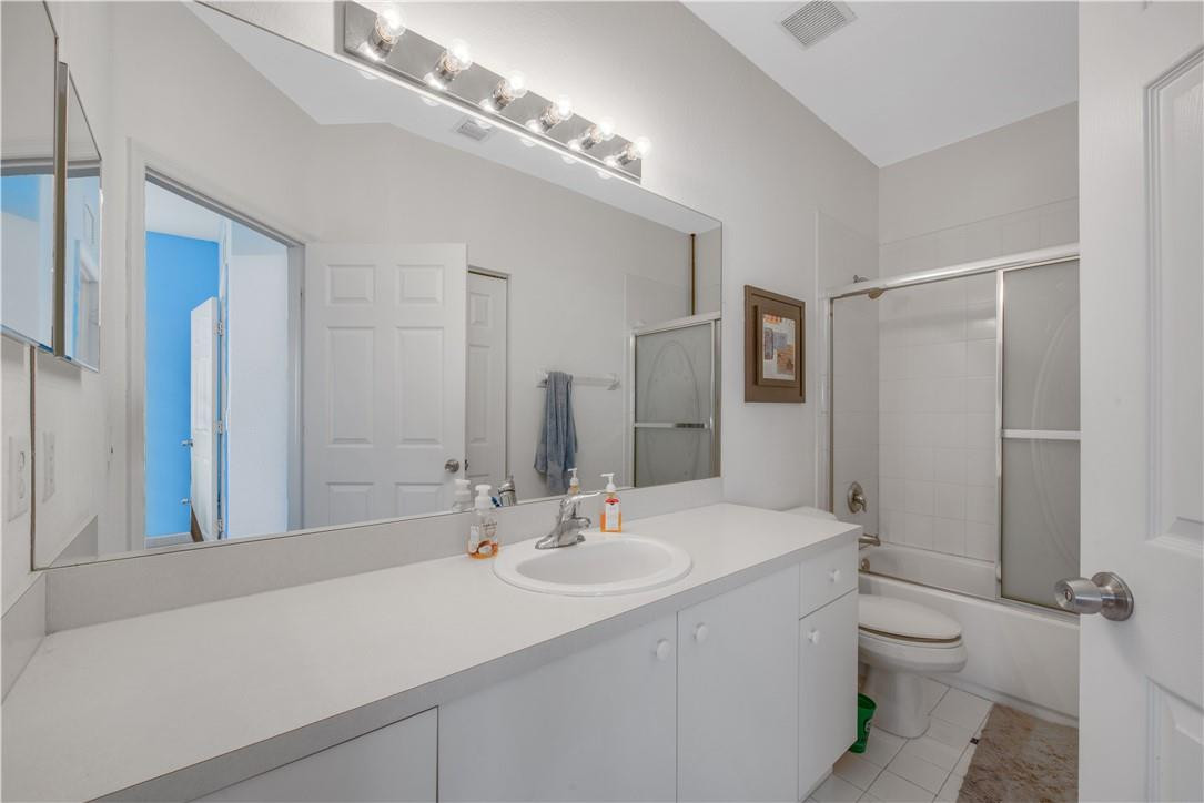 5921 Riverside Avenue Tamarac, FL 33321 - Photo 6 of 22 a bathroom with a sink double vanity granite and a mirror