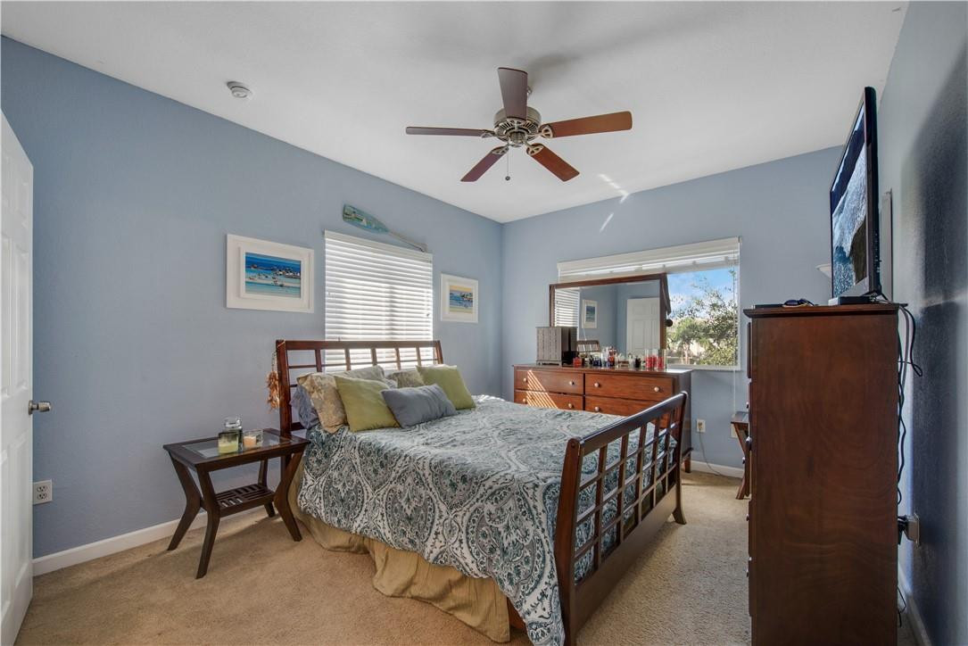 5921 Riverside Avenue Tamarac, FL 33321 - Photo 7 of 22 a bedroom with a bed and wooden floor