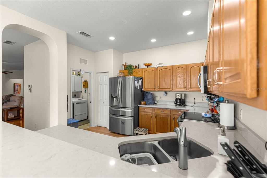 9250 Southwest 96th Court Road Ocala, FL 34481 - Photo 14 of 46 a kitchen with refrigerator and cabinets
