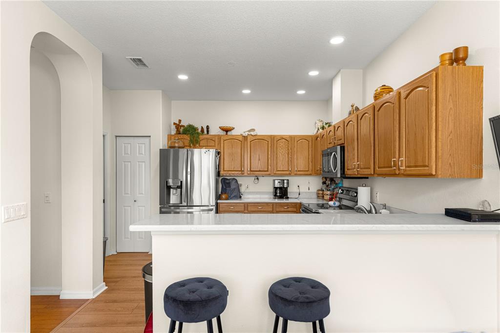 9250 Southwest 96th Court Road Ocala, FL 34481 - Photo 15 of 46 a kitchen with kitchen island granite countertop a sink cabinets and wooden floor