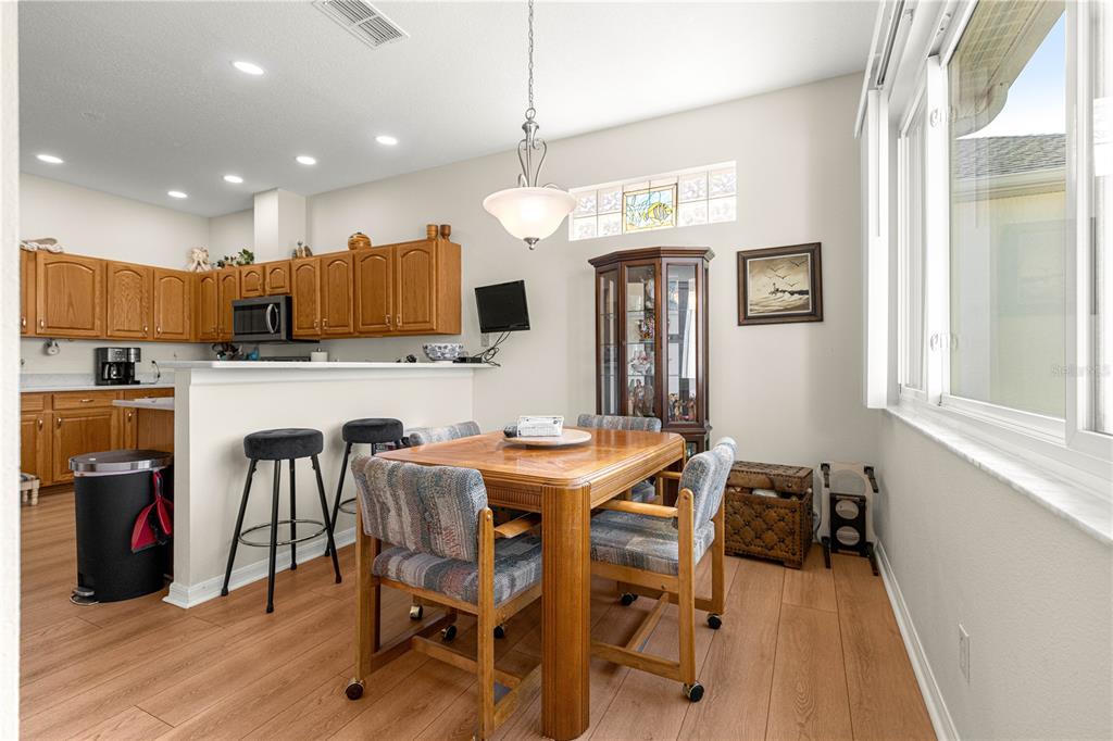 9250 Southwest 96th Court Road Ocala, FL 34481 - Photo 16 of 46 a view of a dining room with furniture and wooden floor