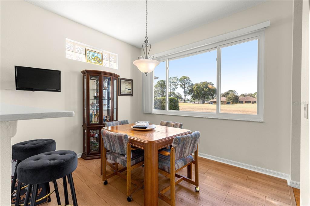 9250 Southwest 96th Court Road Ocala, FL 34481 - Photo 17 of 46 a view of a dining room with furniture window and wooden floor