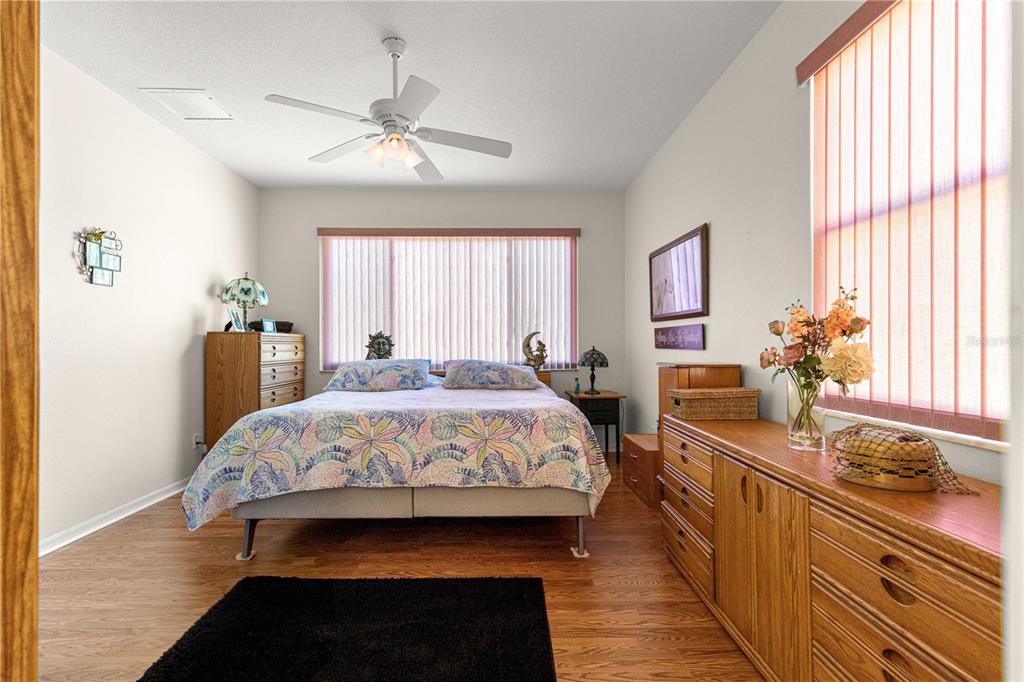 9250 Southwest 96th Court Road Ocala, FL 34481 - Photo 22 of 46 a bedroom with a large bed and a chandelier