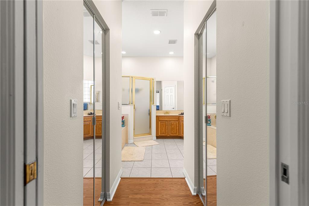 9250 Southwest 96th Court Road Ocala, FL 34481 - Photo 25 of 46 a bathroom with a glass shower door a bathtub a sink and a mirror