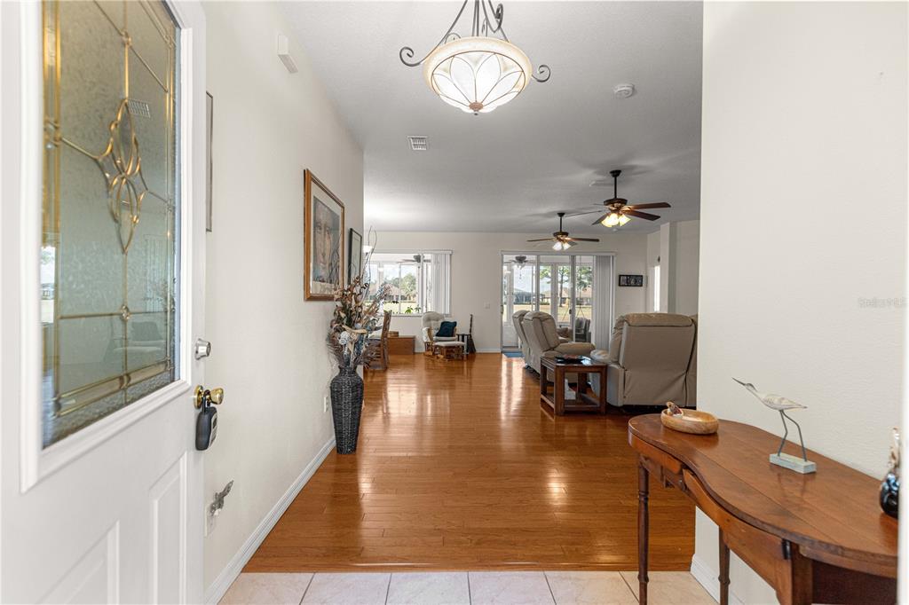 9250 Southwest 96th Court Road Ocala, FL 34481 - Photo 3 of 46 a living room with dining room and wooden floor