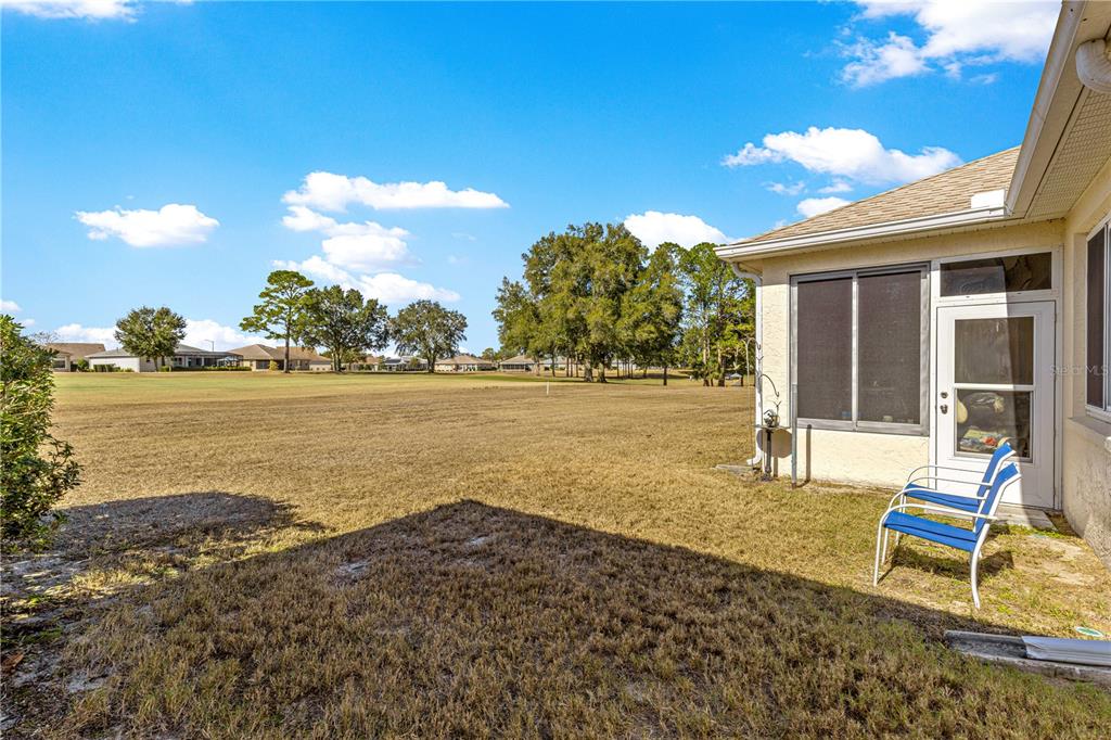 9250 Southwest 96th Court Road Ocala, FL 34481 - Photo 34 of 46 a backyard of a house with table and chairs