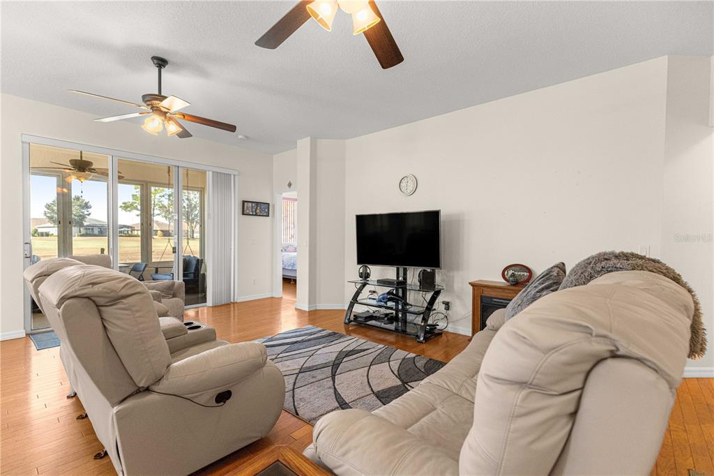 9250 Southwest 96th Court Road Ocala, FL 34481 - Photo 4 of 46 a living room with furniture a flat screen tv and a large window