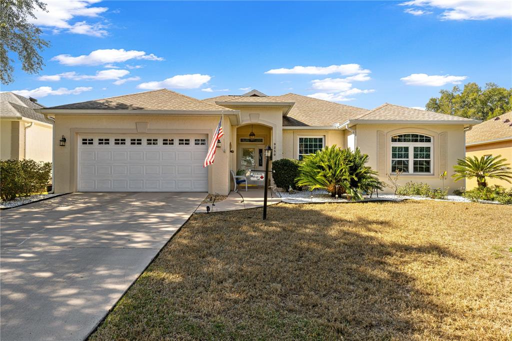 9250 Southwest 96th Court Road Ocala, FL 34481 - Photo 42 of 46 a front view of a house with a yard and garage