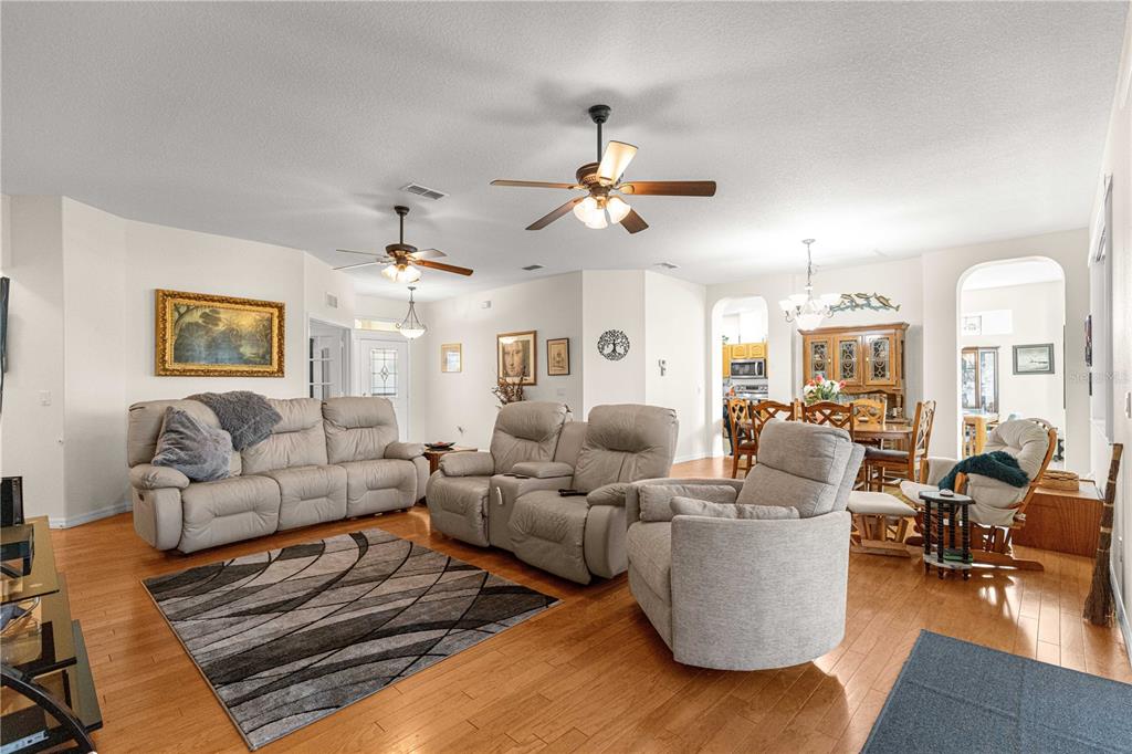 9250 Southwest 96th Court Road Ocala, FL 34481 - Photo 6 of 46 a living room with furniture ceiling fan and a rug