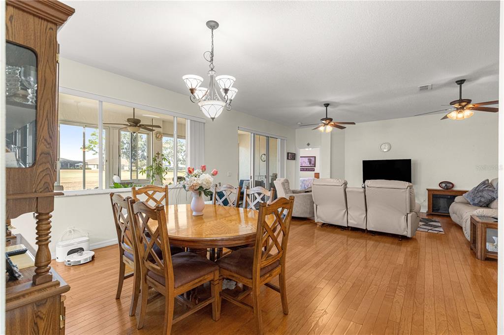 9250 Southwest 96th Court Road Ocala, FL 34481 - Photo 8 of 46 a view of a dining room with furniture and wooden floor