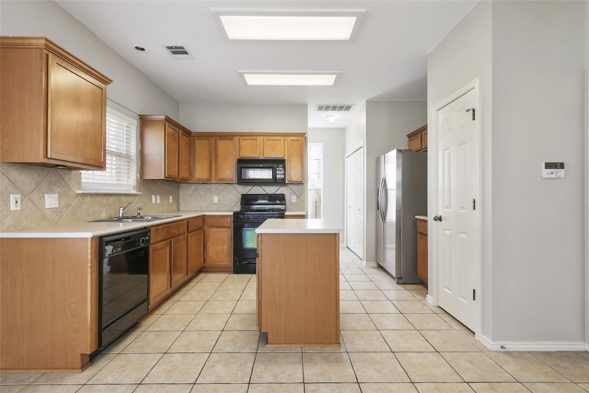 9405 Billingham Trail Austin, TX 78717 - Photo 15 of 40 a kitchen with stainless steel appliances granite countertop a refrigerator and a stove top oven