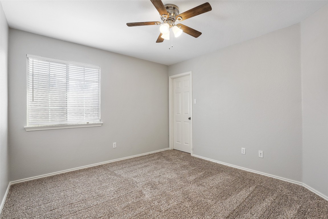 9405 Billingham Trail Austin, TX 78717 - Photo 33 of 40 a view of a room with a ceiling fan and a window