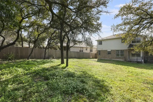 a house is sitting in middle of the garden