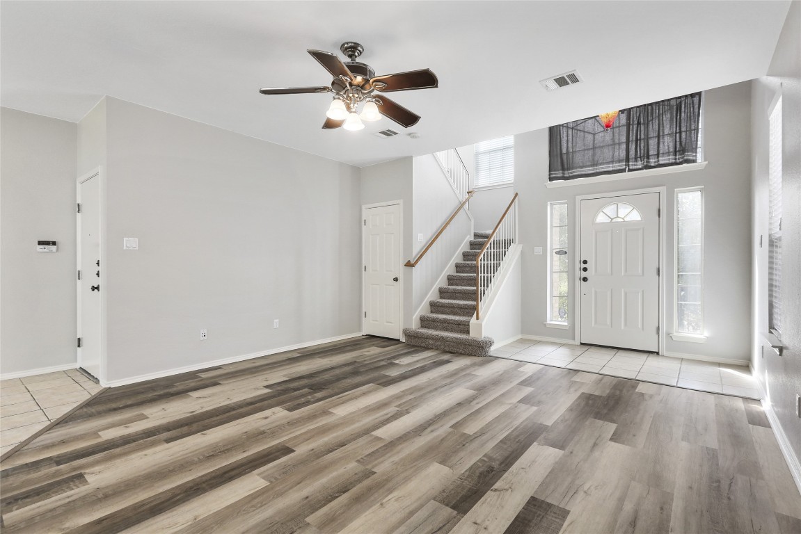 9405 Billingham Trail Austin, TX 78717 - Photo 9 of 40 a view of an empty room with wooden floor and stairs