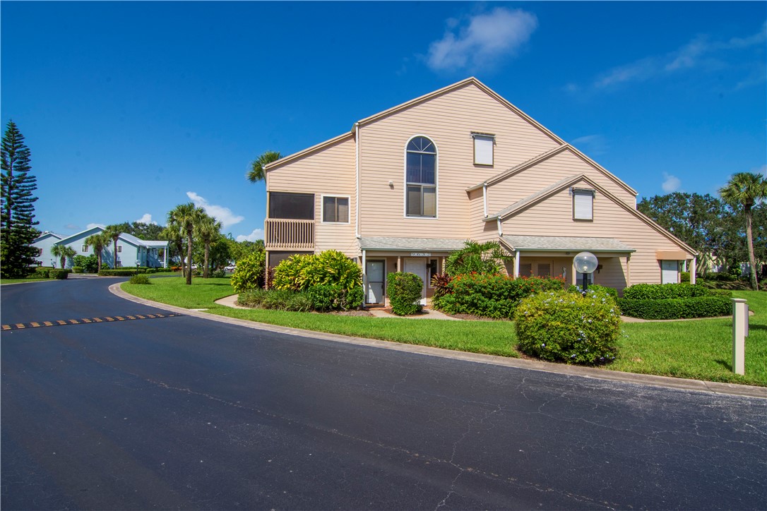 9632 Riverside Drive, Unit 2 Sebastian, FL 32958 - Photo 1 of 29 a front view of a house with a yard and garage