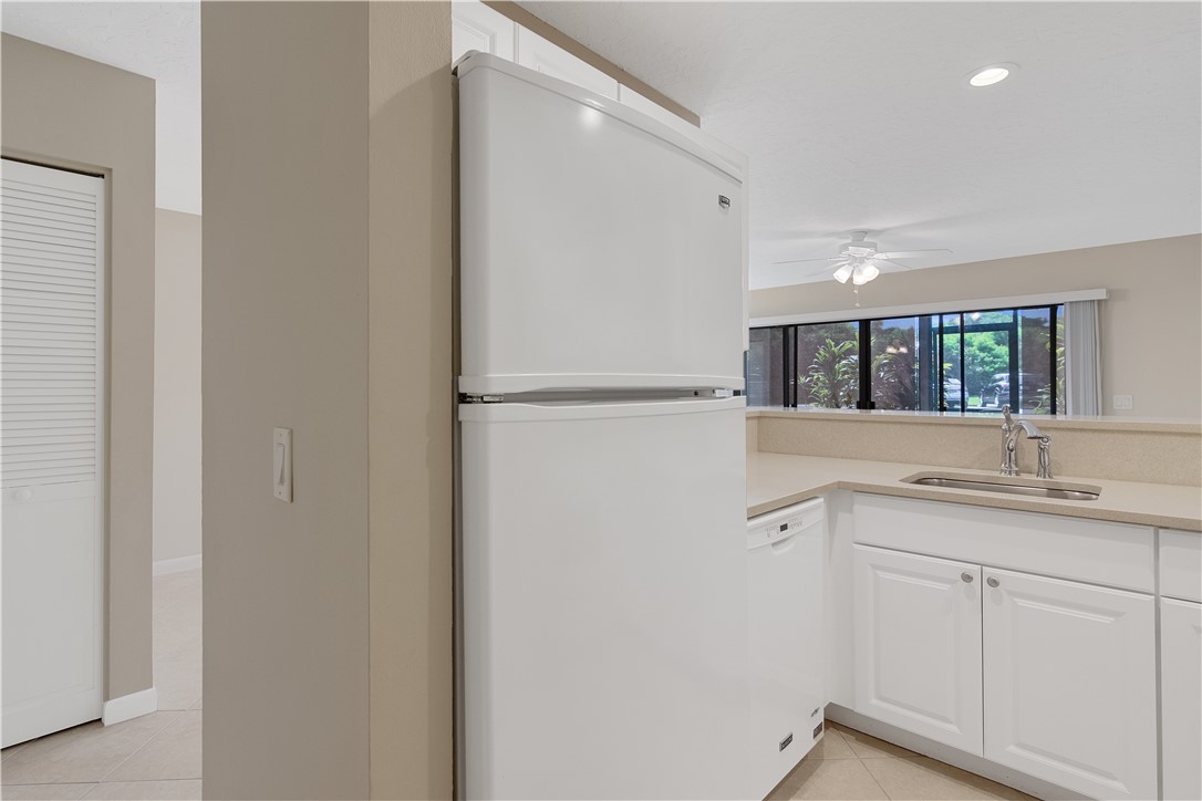 9632 Riverside Drive, Unit 2 Sebastian, FL 32958 - Photo 11 of 29 a kitchen with a sink and refrigerator
