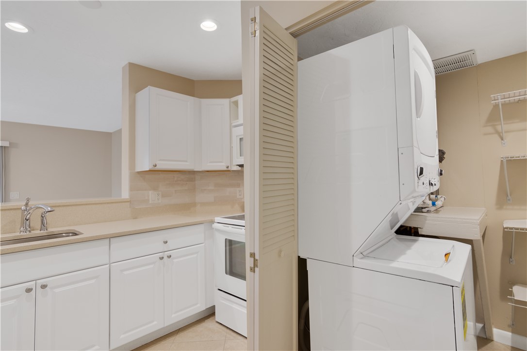 9632 Riverside Drive, Unit 2 Sebastian, FL 32958 - Photo 12 of 29 a kitchen with a sink and cabinets
