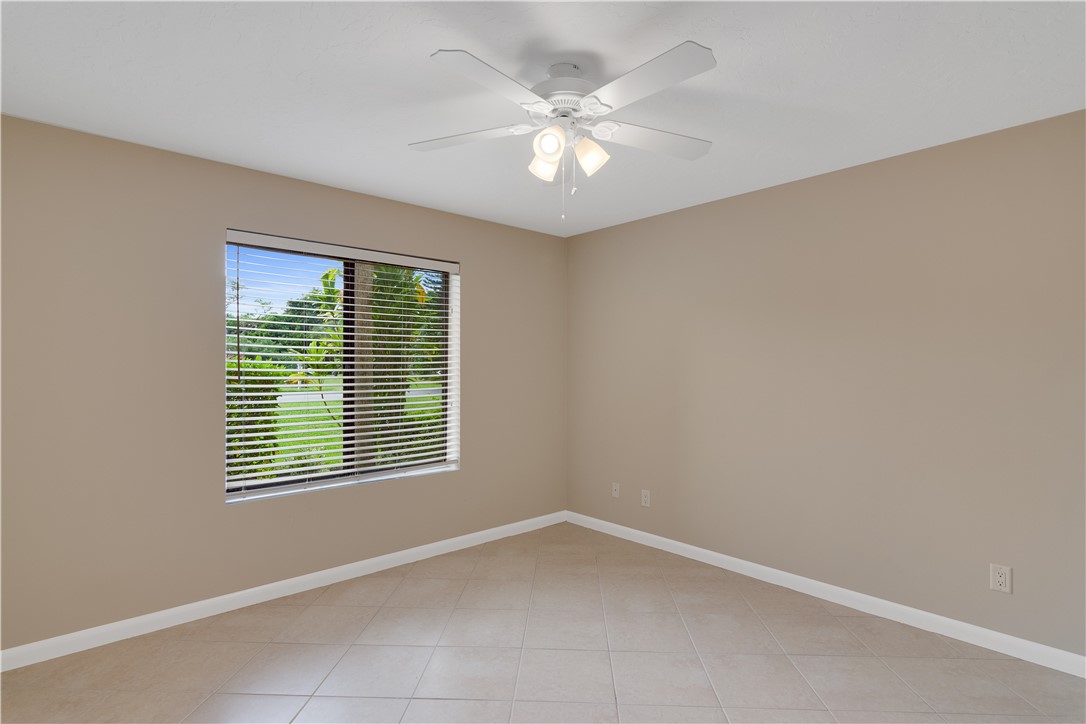 9632 Riverside Drive, Unit 2 Sebastian, FL 32958 - Photo 14 of 29 an empty room with windows and fan