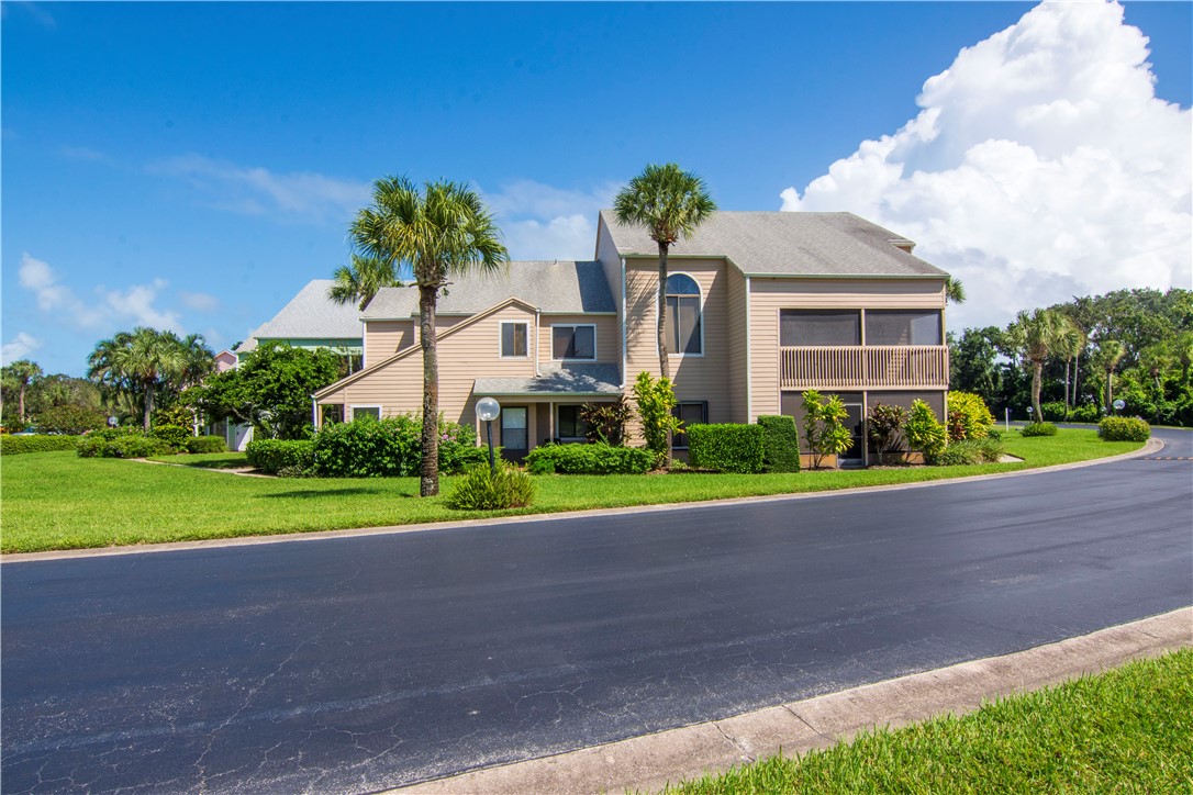 9632 Riverside Drive, Unit 2 Sebastian, FL 32958 - Photo 2 of 29 a front view of a house with a yard and garage