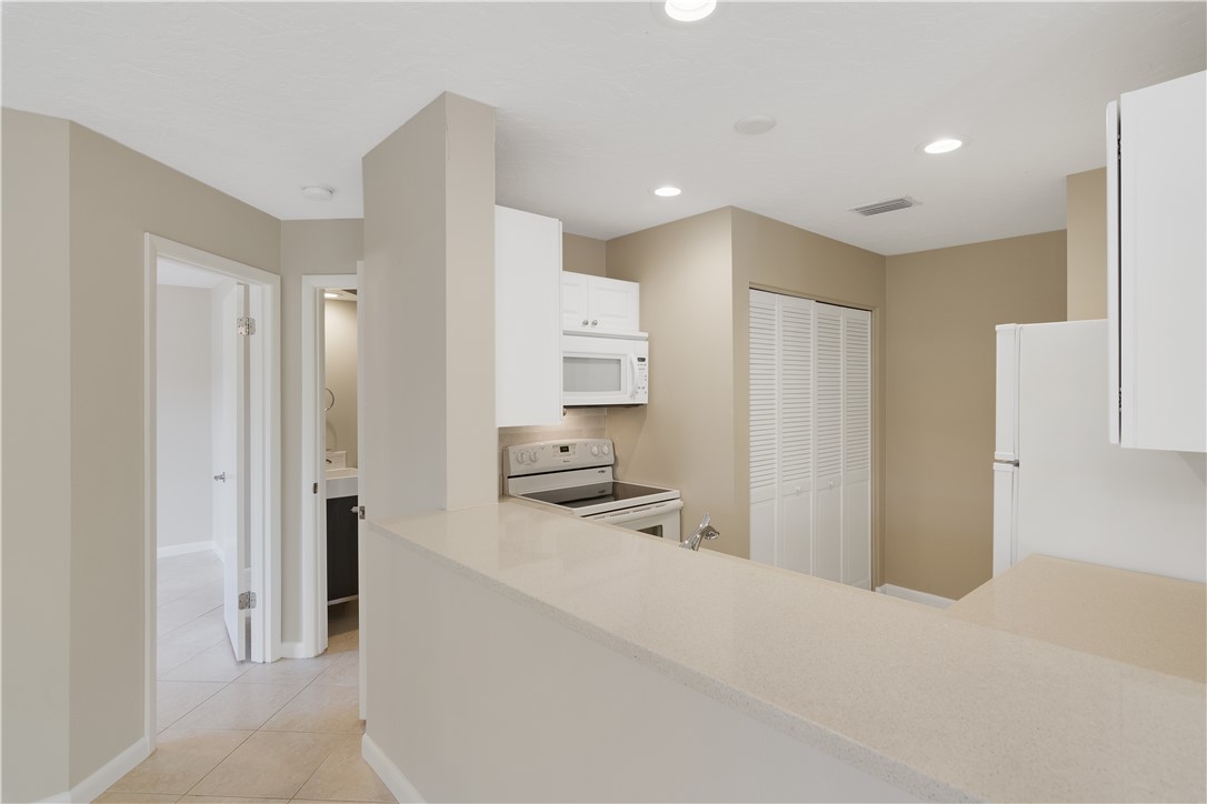 9632 Riverside Drive, Unit 2 Sebastian, FL 32958 - Photo 10 of 29 a walk in closet with a kitchen