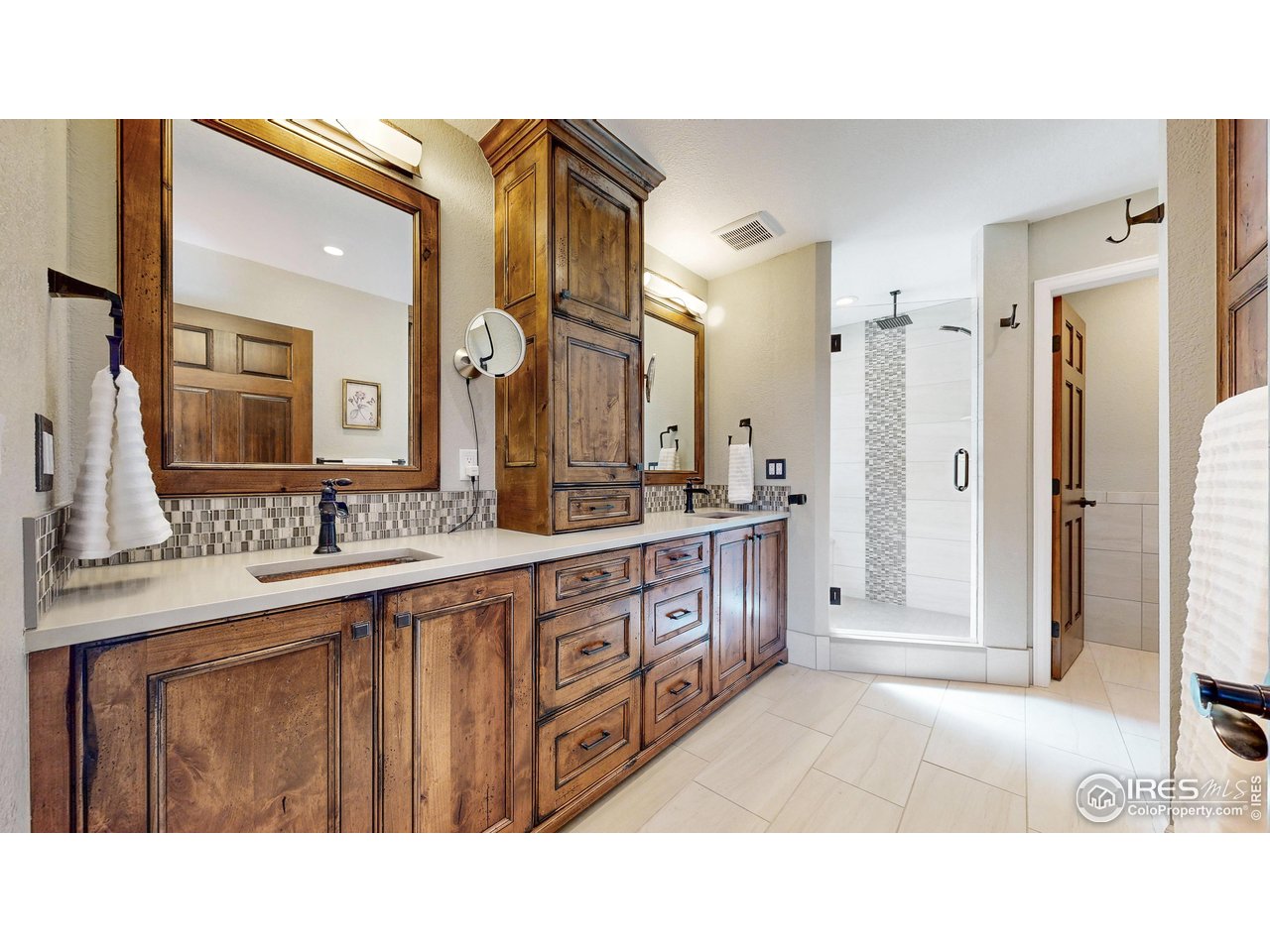 898 Eagle Ridge Court Loveland, CO 80537 - Photo 15 of 40 a bathroom with a sink double vanity granite tub shower and a mirror