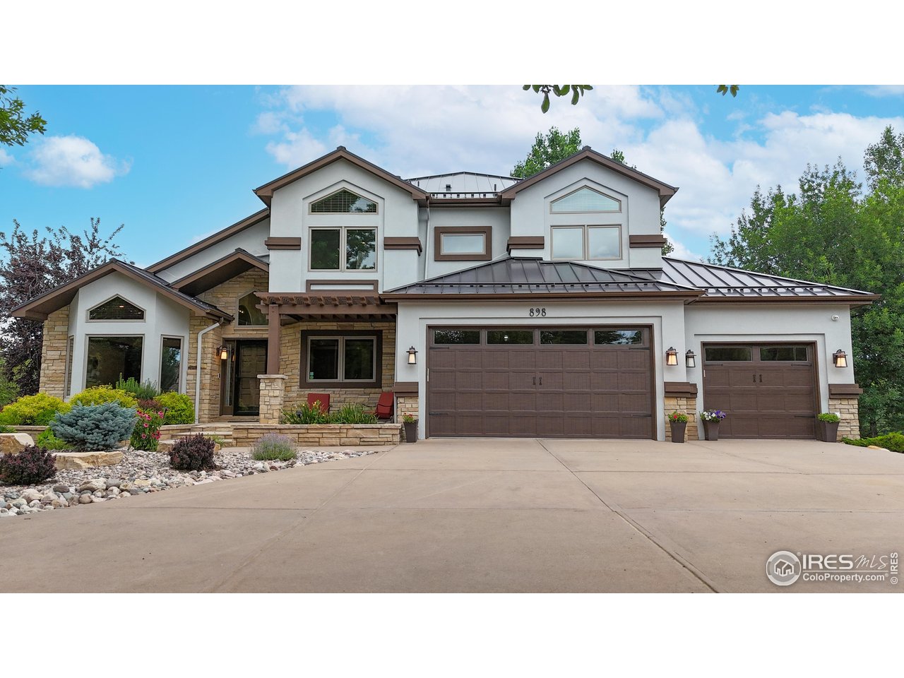 898 Eagle Ridge Court Loveland, CO 80537 - Photo 2 of 40 a house view with a garden space