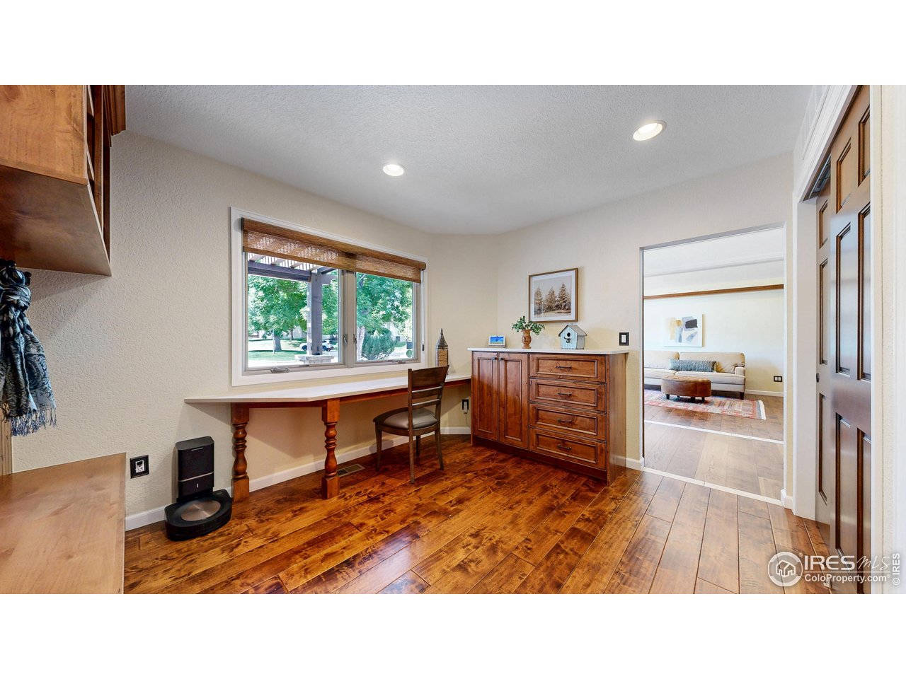 898 Eagle Ridge Court Loveland, CO 80537 - Photo 21 of 40 a living room with furniture and a wooden floor