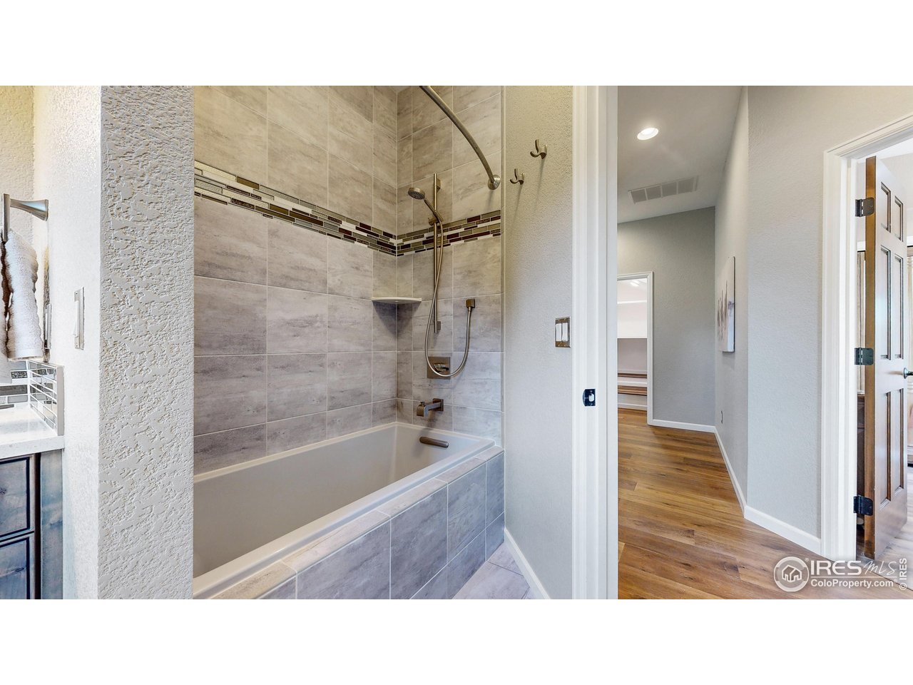 898 Eagle Ridge Court Loveland, CO 80537 - Photo 28 of 40 a bathroom with a tub shower and sink