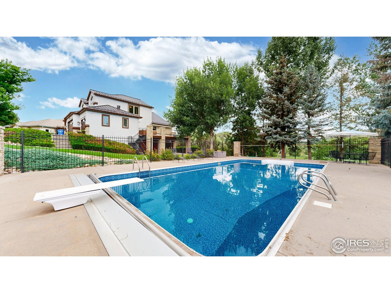 898 Eagle Ridge Court Loveland, CO 80537 - Photo 39 of 40 a view of a swimming pool with a yard