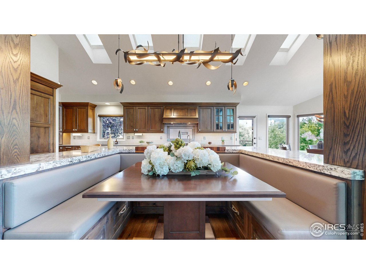 898 Eagle Ridge Court Loveland, CO 80537 - Photo 8 of 40 a kitchen with a table chairs and a dining table