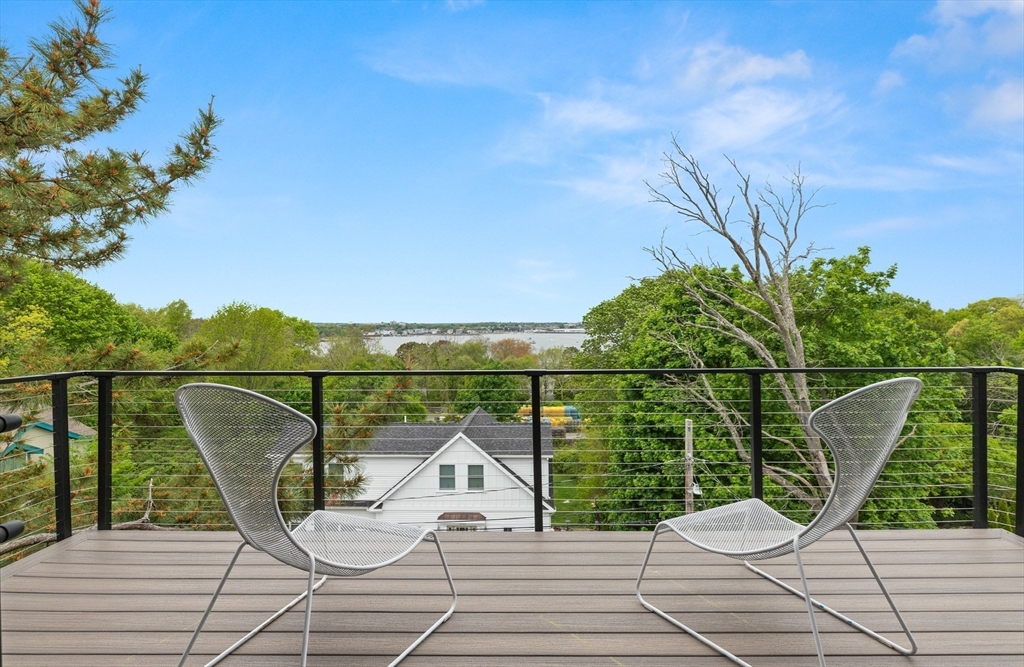 9 Upland Road Marblehead, MA 01945 - Photo 14 of 42 a view of roof deck with seating space and trees in the background
