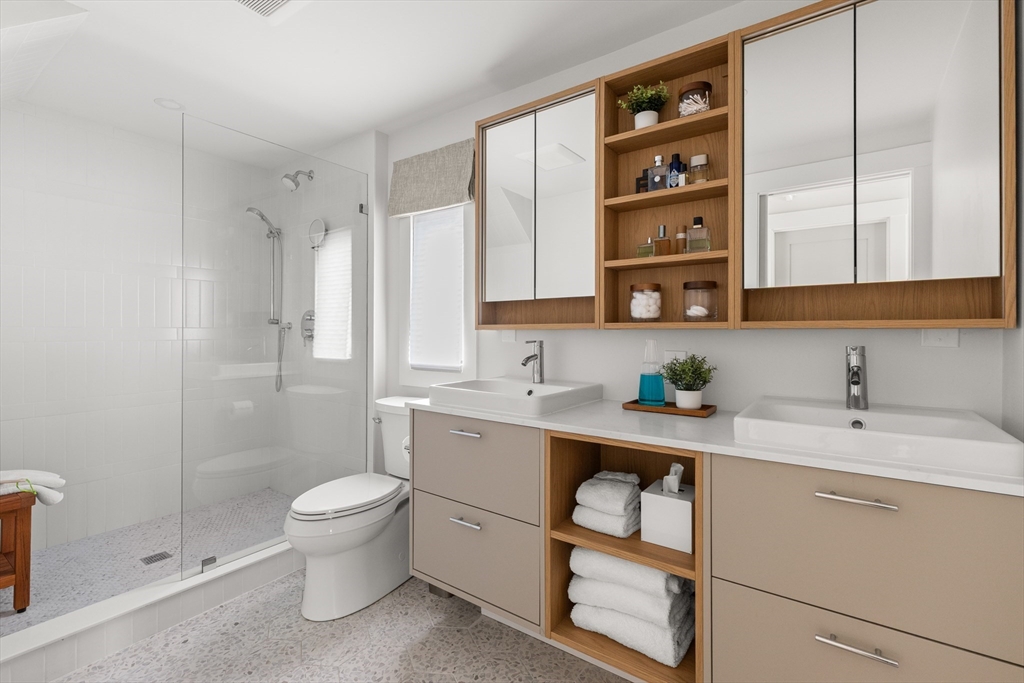 9 Upland Road Marblehead, MA 01945 - Photo 22 of 42 a bathroom with a sink a toilet and shower