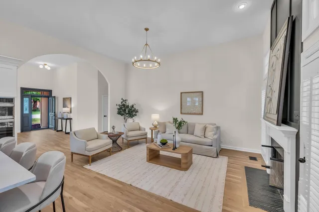 a living room with furniture a fireplace and a flat screen tv