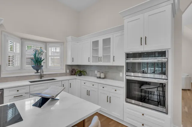 a kitchen with a sink stove and cabinets
