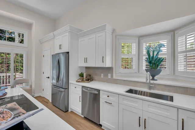 a kitchen with a refrigerator and a sink