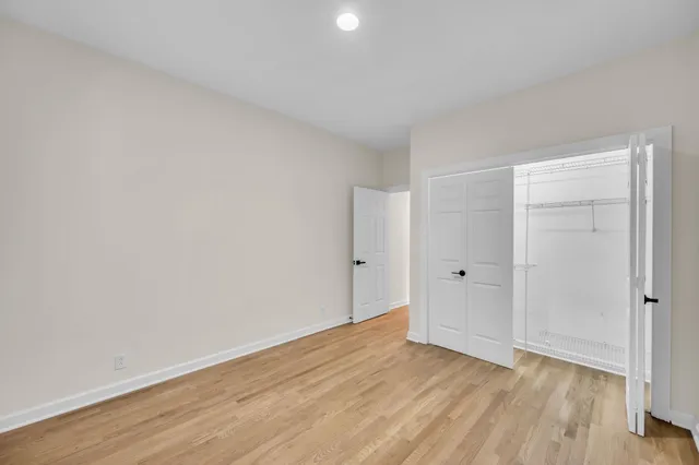 a view of an empty room and wooden floor