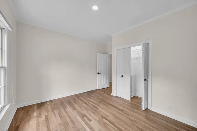 a view of an empty room and wooden floor