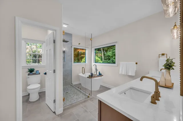 a bathroom with a sink toilet and shower